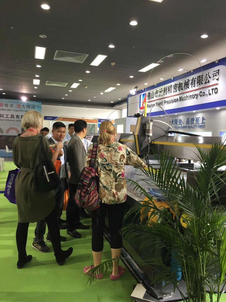Foshan Yuanli Precision Machinery exhibition booth showing a configured waterjet machine