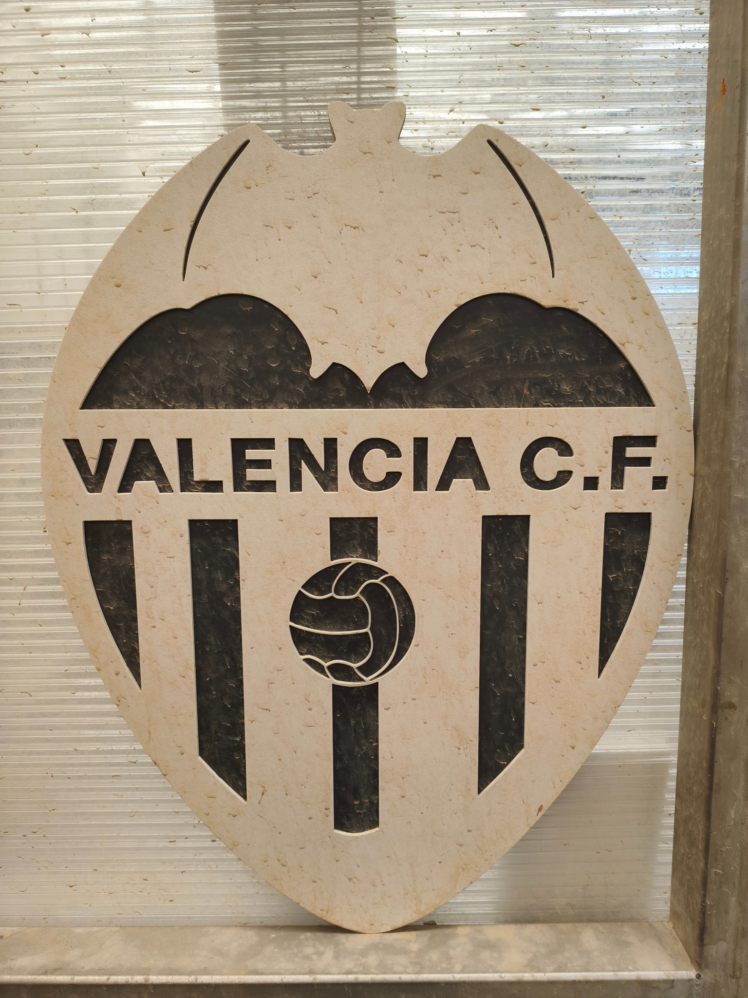 Decorative pattern and lettering cut in 25 mm ceramic, an AC five-axis waterjet series example